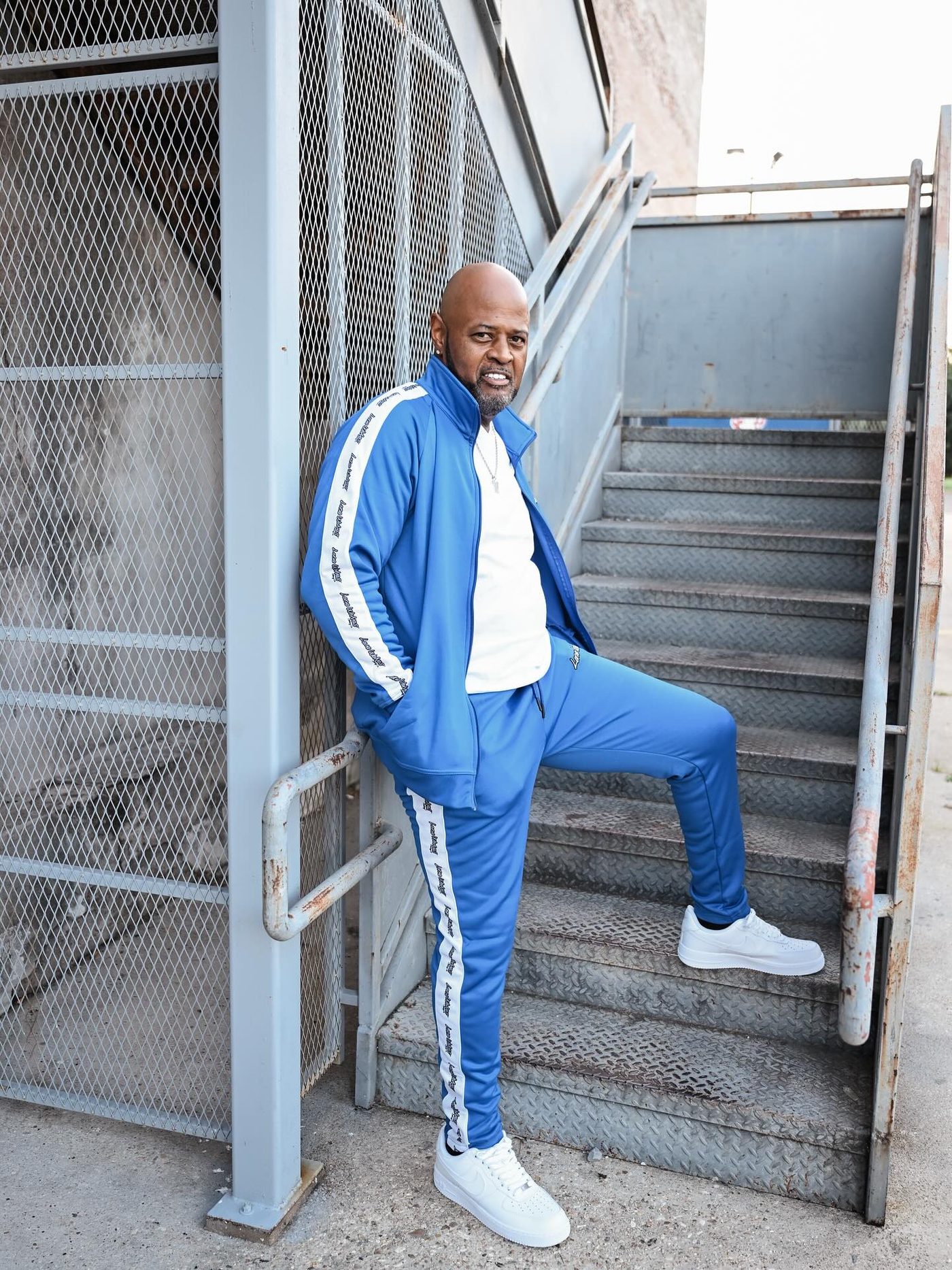 Royal blue Lone Wolves track suit on a stairwell