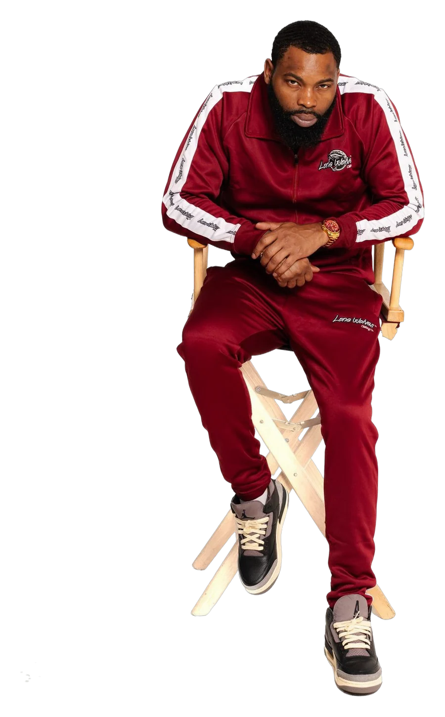 Man seated in a maroon Lone Wolves track suit