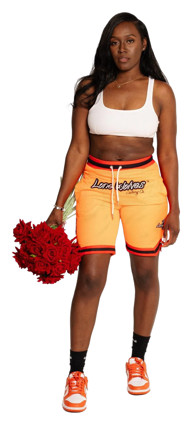 Woman in an orange Lone Wolves set with pom poms