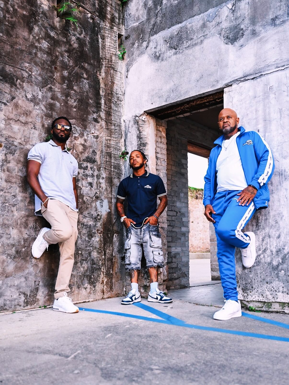 Three men in Lone Wolves pieces in a stone doorway